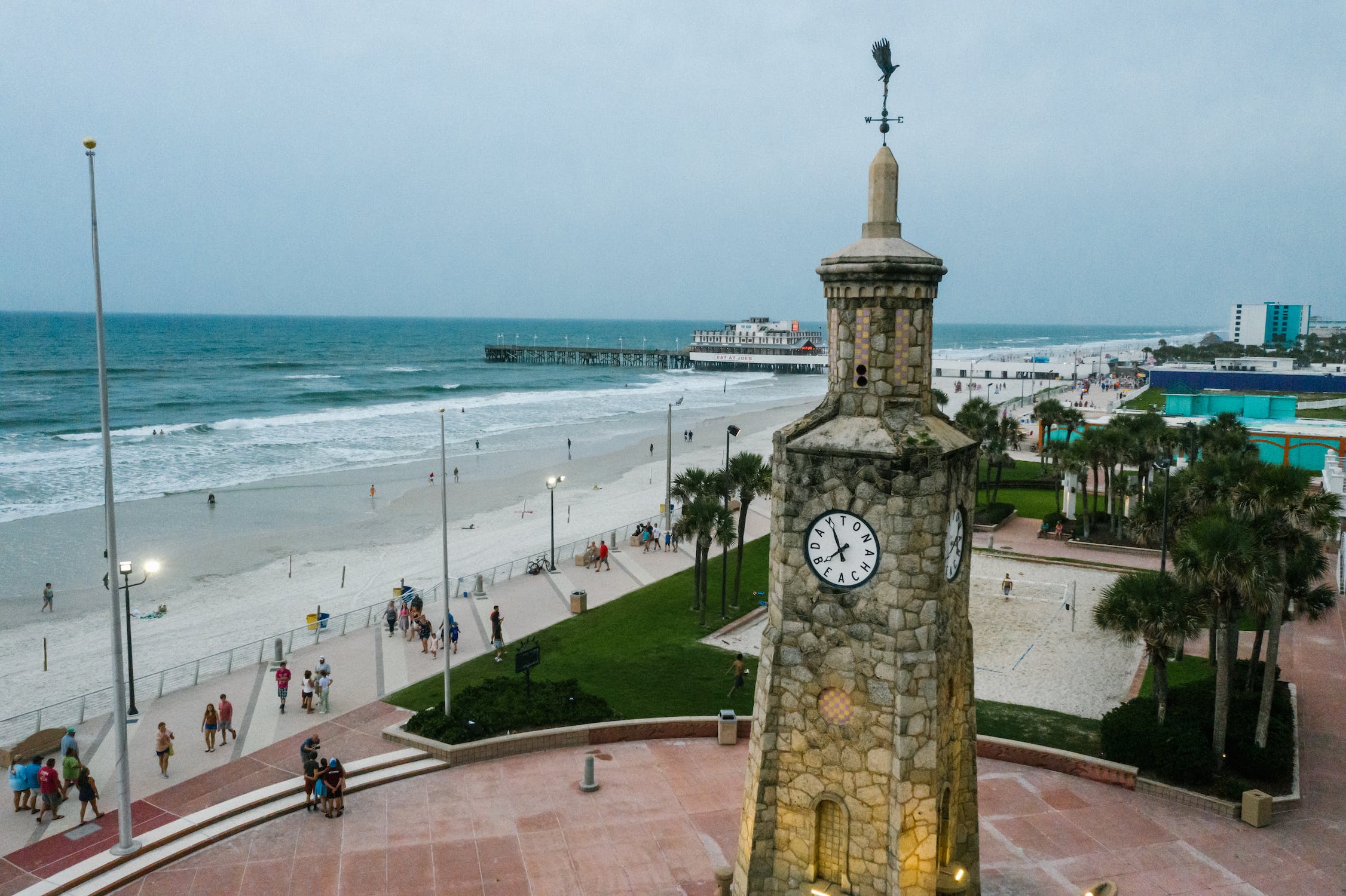 Aerial view of the Daytona Beach Coquina Clock Tower with the boardwalk and ocean in the background, showcasing the coastal charm of Daytona Beach, Florida.